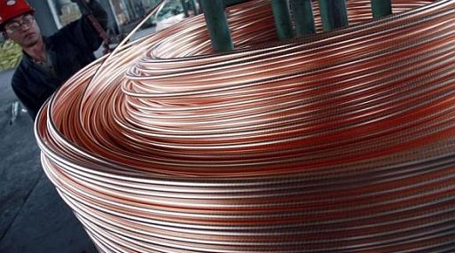 An employee unloads copper at a factory in Nantong, Jiangsu province, June 18, 2011. REUTERS/China Daily